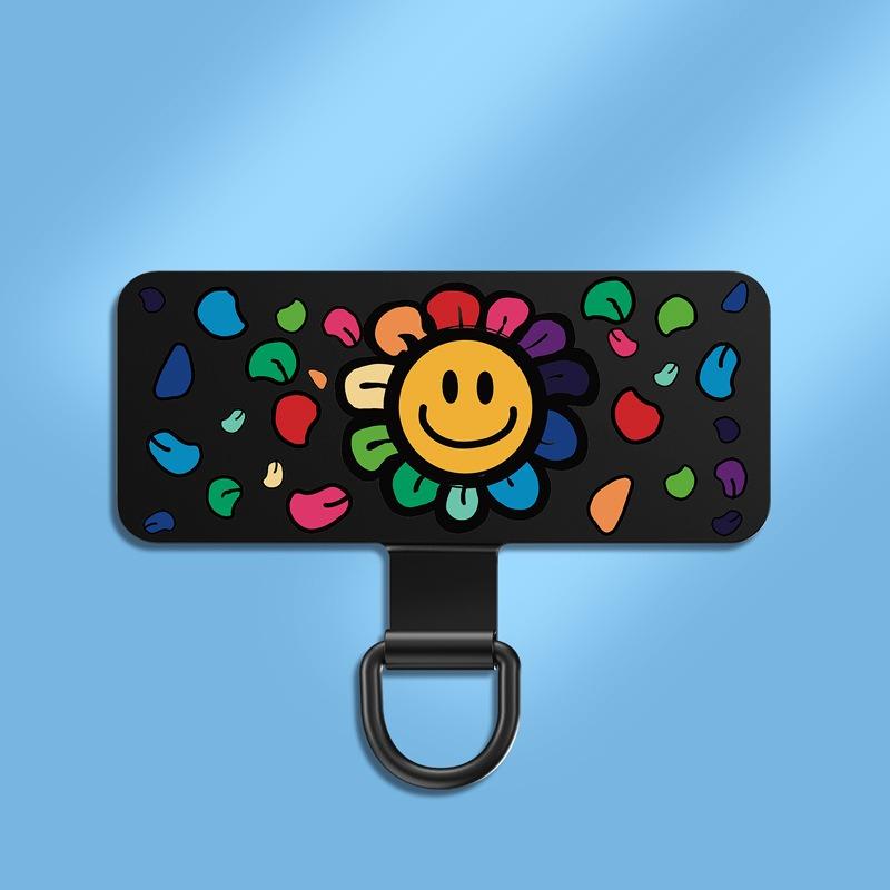 Y143 ultra-thin stainless steel phone tether tab in the Smiley Face print &mdash; a black anchor pad with a reinforced D-ring